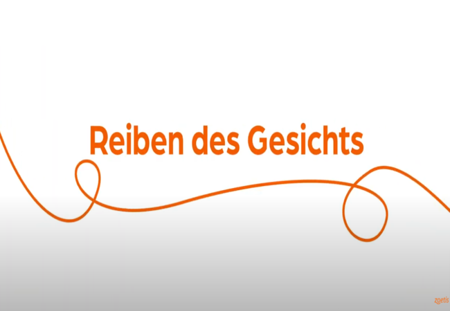 Text „Reiben des Gesichts“ mit orangefarbener Spirale auf weißem Hintergrund.