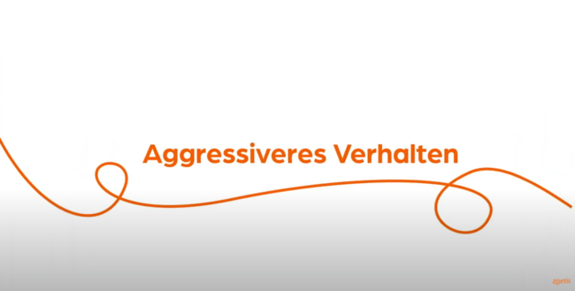 Text „ Aggressiveres Verhalten “ mit orangefarbener Spirale auf weißem Hintergrund.