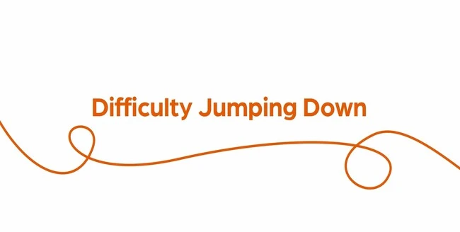 Text "Difficulty jumping down" with orange swirl on white background.