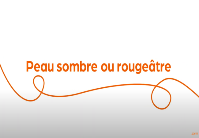 Texte « Peau sombre ou rougeâtre » avec une spirale orange sur fond blanc.